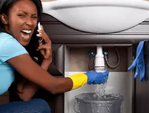 Emergency plumbing repair for a leaking sink drain under a bathroom vanity in Worcester, MA